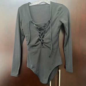 Black body suit, front criss cross v neck. Worn once.